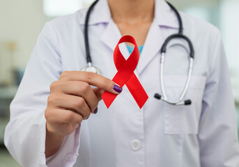 Medical Professional Holds Red Ribbon for HIV AIDS Awareness