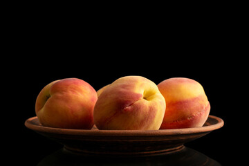 Juicy peaches isolated on black background, close-up.