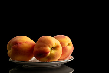 Juicy peaches isolated on black background, close-up.