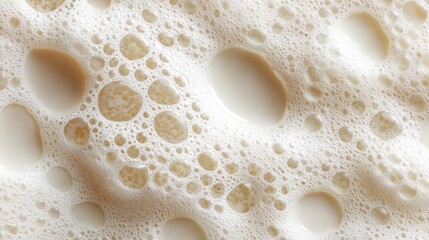 Macro milk foam bubbles creating creamy white texture