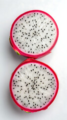 Fototapeta premium Vibrant dragon fruit slices showcasing white flesh and black seeds against a clean white background