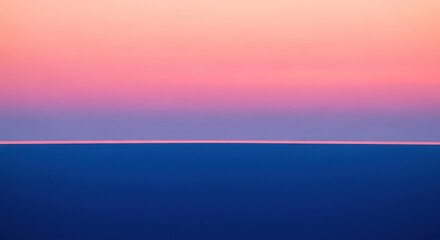 Fototapeta premium Tranquil sunset hues paint the sky above a calm, deep ocean.