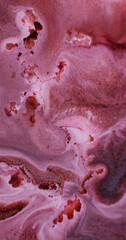 Spilling substance. Paint art. Defocused pink maroon bronze color water glitter liquid flowing on...