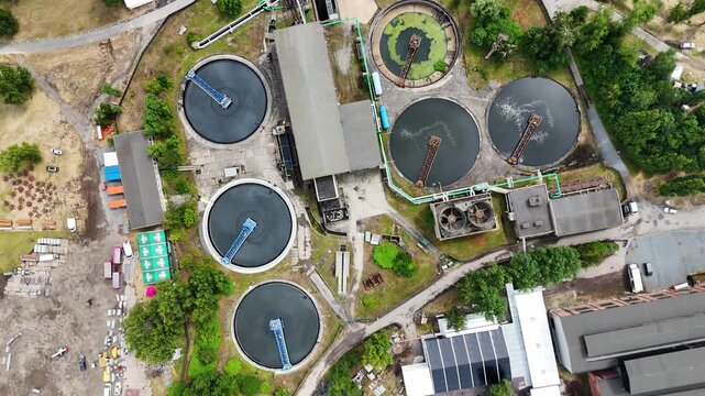 Aerial view of a modern wastewater treatment plant with circular clarifiers