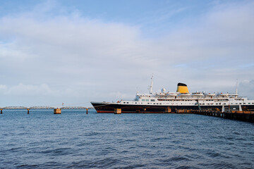Luxury Cruise Ship Docked at Scenic Waterfront On A Clear Day
