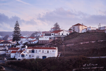 Obraz premium Charming European Village at Sunset with Quaint Houses and Rolling Hills