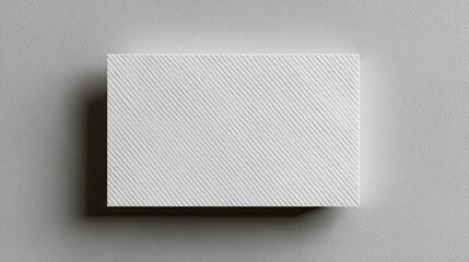 A 4K photo of textured business card mockup on a grey background. 85x55 mm.
