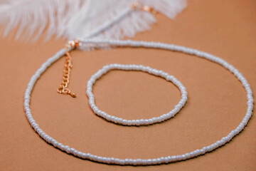 Beautiful handmade necklace and braclet on background