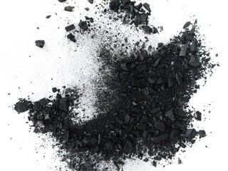 Top view of scattered black charcoal powder particles. Crushed black charcoal powder scattered on white background. Black dust abstract texture like exploding effect.