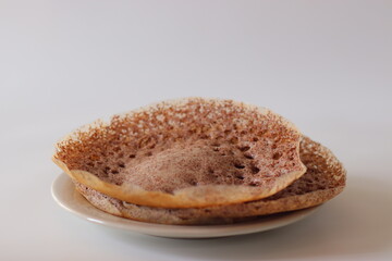 Ragi Appam, Freshly cooked Appam with lacy edges and soft center, made from fermented finger millet batter
