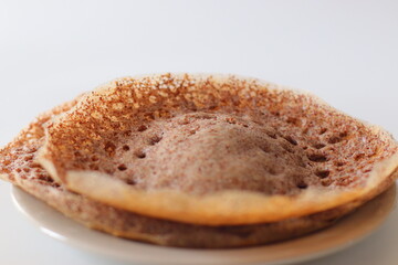 Ragi Appam, Freshly cooked Appam with lacy edges and soft center, made from fermented finger millet batter