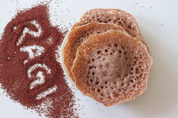 Ragi appams with crisp edges and soft centers served on a ceramic plate, made from fermented finger millet batter