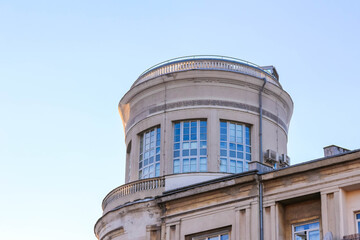 Historic cylindrical tower building with classical windows and ornate architectural details...