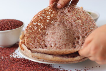 Ragi appams made from finger millet flour served with creamy vegetable stew, garnished with cashews and herbs