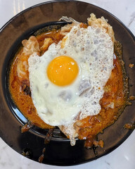 Crispy roti in curry with sunny egg.