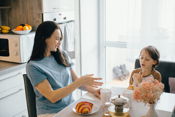 Mother and son sharing a pleasant breakfast at home