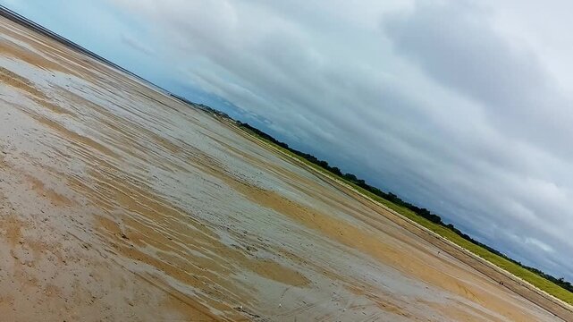 Aerial Rotating Shot of Normandy Beach at Low Tide - Horizontal Pan to the Right 