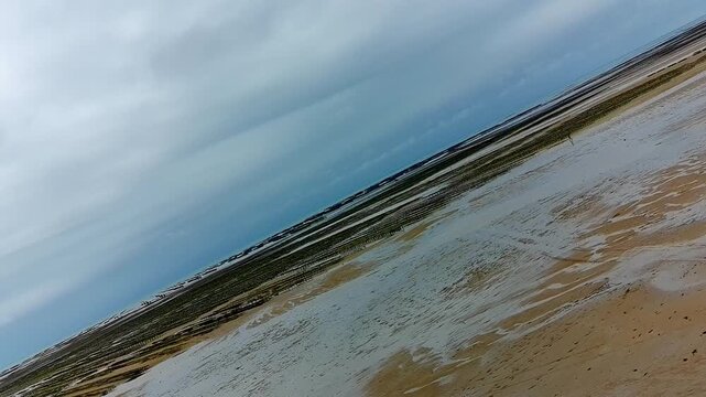 Aerial Rotating Drone Shot of Oyster Farm at Low Tide - Rightward Rotation 