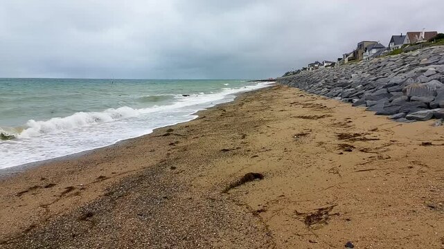 Aerial Drone Shot Retreating Between Sandy Beach and Ocean - Cloudy Sky 
