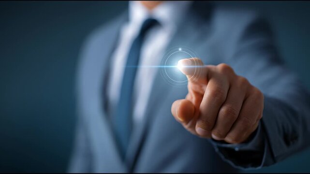 Business Touchpoint: A close-up shot of a suited individual's finger pointing toward a glowing interface, capturing a sense of innovation and technological interaction.