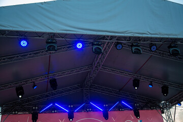 Stage lights and rotating heads hang above the stage colored lighting party