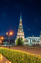 Fototapeta premium The ancient leaning red brick Syuyumbike Tower at night on the territory of the Kazan Kremlin. Russia