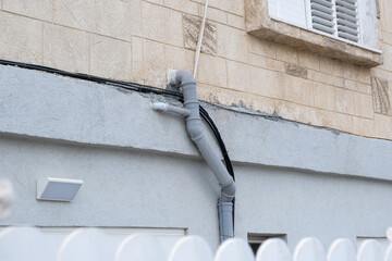 Plumbing installation of water pipe and sewerage system on the building exterior wall in israel
