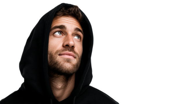 Young man in black hoodie looking up with thoughtful expression
