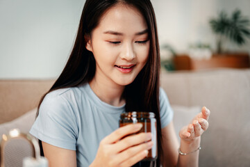 Woman prepares essential daily supplements and vitamins for longevity and healthy lifestyle at home