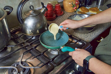Homemade pancakes prepared in a home kitchen with completely homemade preparation. Dessert cooking...