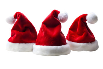 Three red santa hats with white trim and pom poms isolated on a transparent background