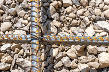 Rebar tied together, over stone base prior to concrete being installed.  	