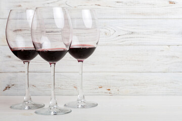 Many glasses of red wine at wine tasting. Concept of red wine on colored background. Top view, flat lay design