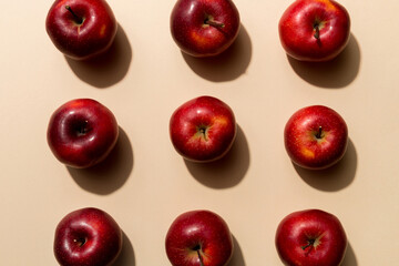 Many red apples on colored background, top view. Autumn pattern with fresh apple above view