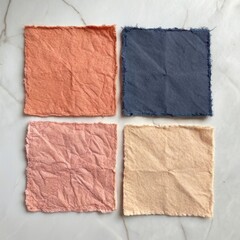 Fototapeta premium Four textured square swatches of handmade paper in peach pink navy and beige
