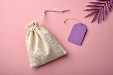 Simple Drawstring Bag With Purple Tag on Pastel Pink Background