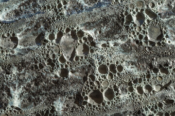 Rough rock texture. The rock is grey and has a lot of holes. Full frame abstract backgrounds