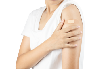 Woman holding her arm with a bandage after getting a vaccine shot. Patient after Covid-19 vaccination. isolated on white background with clipping path.