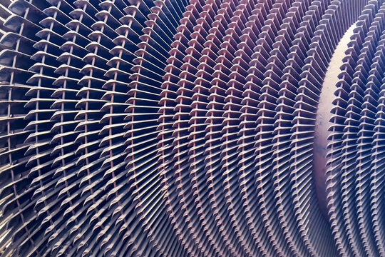 Detailed close-up of industrial steam turbine rotor and blades used in power generation. Ideal for: energy infrastructure, mechanical engineering, industrial design, and equipment manufacturing.