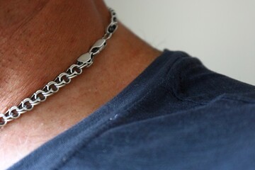 Close up of silver chain necklace on mans neck ,casual fashion detail
