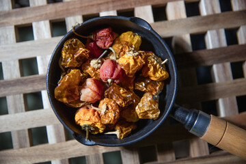 Dried chili peppers in a black iron pot