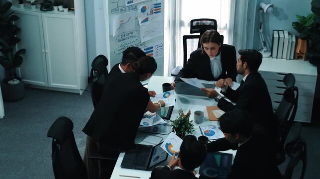Top view of investor handed financial document to manager while explain marketing idea at meeting table. People looking at growing graph while listen business team discussion. Time lapse. Directorate.