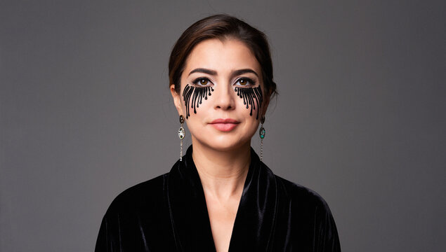 Portrait of Woman with Black Teardrop Makeup and Black Velvet Robe