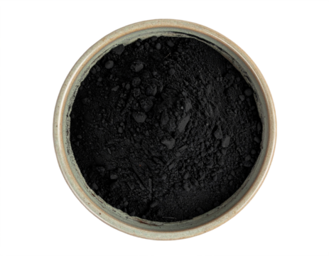 Pure activated charcoal powder in rustic bowl for detox, skincare, and wellness treatments
