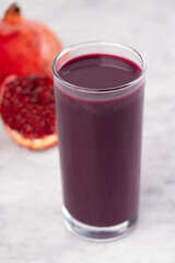 Fresh pomegranate juice. Healthy and vibrant drink. Glass of natural pomegranate juice on white background.Organic red juice full of antioxidants. Refreshing pomegranate Juice. superfood in a glass