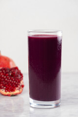 Fresh pomegranate juice – Healthy and vibrant drink – Glass of natural pomegranate juice on white background – Organic red juice full of antioxidants – Refreshing pomegranate Juice – superfood in a gl