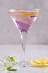 Lavender Gin Tonic with Lemon and Ice in a Crystal Glass