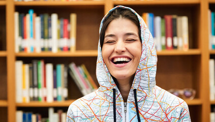 Portrait of Woman in Map-Patterned Hoodie Against Bookshelf