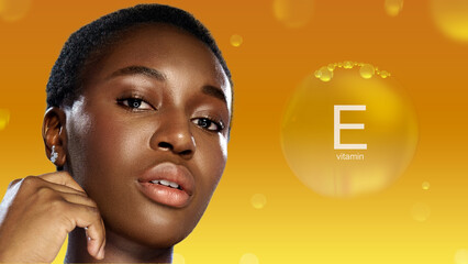 Model showcases radiant skin features with vitamin E in vibrant orange background during a skincare...