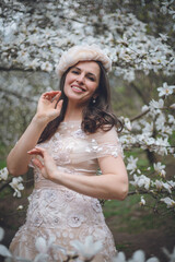 Romantic Female Portrait in Blooming Magnolia Park